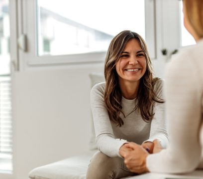 Smiling woman, talking to psychologist, feeling positive.
